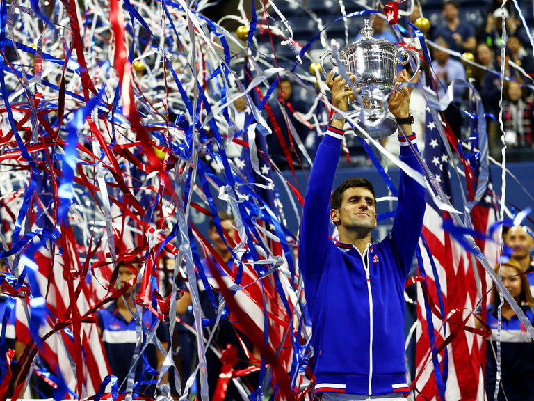 Novak Djokovic holds up the US Open trophy after winning his 10th major.